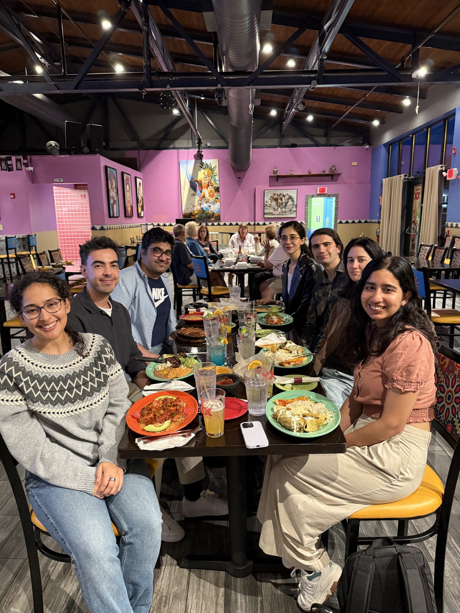 Lab members around the table at a group dinner.