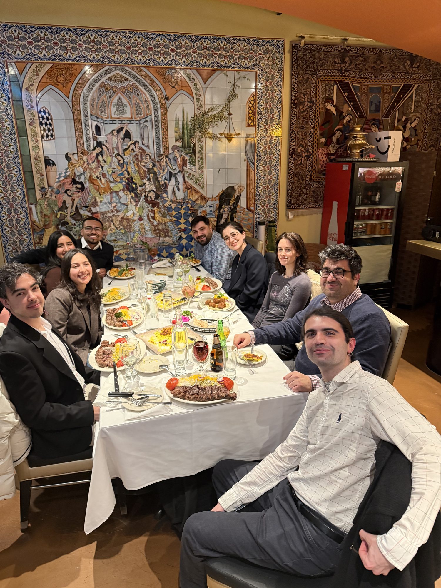 The lab sharing a meal together at a group dinner.